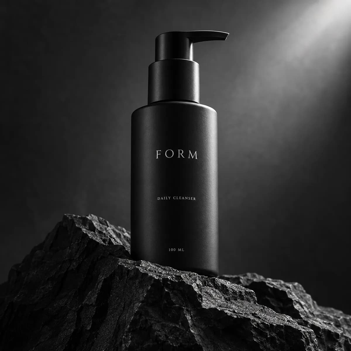 Fictional black skincare bottle on slate, a sample product still